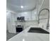 Bright kitchen featuring white cabinets, subway tile backsplash, and stainless steel appliances at 4934 Avery Rd, New Port Richey, FL 34652