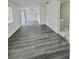 Spacious living room featuring modern gray wood flooring with natural light at 4934 Avery Rd, New Port Richey, FL 34652