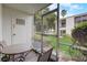 Private screened patio with table and chairs, offering backyard views at 219 S Mcmullen Booth Rd # 175, Clearwater, FL 33759