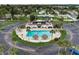 Community pool with lounge chairs and umbrellas at 219 S Mcmullen Booth Rd # 175, Clearwater, FL 33759