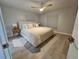 Bright bedroom with king-size bed, ceiling fan, and hardwood floors at 975 Coronado Dr, Punta Gorda, FL 33950