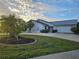 House exterior featuring a metal roof and landscaping at 975 Coronado Dr, Punta Gorda, FL 33950