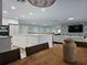 Modern kitchen with white cabinetry, a large island, and a stylish backsplash at 975 Coronado Dr, Punta Gorda, FL 33950
