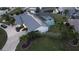 Aerial view of canal-front home with pool and screened enclosure at 975 Coronado Dr, Punta Gorda, FL 33950