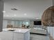 Open kitchen with white island, modern appliances, and view into living room at 975 Coronado Dr, Punta Gorda, FL 33950
