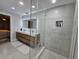 Spa-like bathroom featuring a double vanity and a glass-enclosed shower at 975 Coronado Dr, Punta Gorda, FL 33950