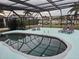 Inviting pool area with screened enclosure and lounge chairs near canal at 975 Coronado Dr, Punta Gorda, FL 33950