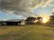 Large metal barn at sunset with grassy field at 40610 State Road 64 E, Myakka City, FL 34251