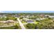 Overhead view of a single Gathering house situated in a quiet neighborhood with neatly paved streets and lush vegetation at 13527 Ainsworth Ln, Port Charlotte, FL 33981