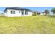 Expansive backyard showcasing the home's rear exterior and lush green lawn at 13527 Ainsworth Ln, Port Charlotte, FL 33981