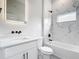 Modern bathroom featuring a sleek vanity, illuminated mirror, and tiled shower-tub combination at 13527 Ainsworth Ln, Port Charlotte, FL 33981
