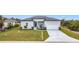 Charming single-story home featuring a neutral color scheme, two-car garage, and a well-manicured lawn at 13527 Ainsworth Ln, Port Charlotte, FL 33981