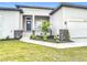 An inviting front porch with stone accents and white railings welcomes you to this beautiful home at 13527 Ainsworth Ln, Port Charlotte, FL 33981