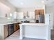 Modern kitchen featuring stainless steel appliances, an island and two-tone cabinetry at 13527 Ainsworth Ln, Port Charlotte, FL 33981