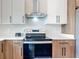 Modern kitchen with stainless steel appliances and stylish cabinetry at 13527 Ainsworth Ln, Port Charlotte, FL 33981