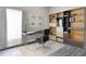 Modern office space featuring a sleek desk, ergonomic chair, shelving unit, and natural light at 13527 Ainsworth Ln, Port Charlotte, FL 33981