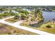 Scenic aerial view of a community park with a covered picnic area and walking paths along a tranquil waterway at 14112 Monserrate Ln, Port Charlotte, FL 33981