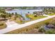 Stunning waterfront home featuring a private dock and lush tropical landscaping along the canal at 14112 Monserrate Ln, Port Charlotte, FL 33981