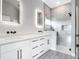 Bright bathroom featuring a dual vanity, quartz countertops, and a glass enclosed shower at 14112 Monserrate Ln, Port Charlotte, FL 33981