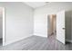 Neutral bedroom with gray wood floors and an open doorway at 14112 Monserrate Ln, Port Charlotte, FL 33981