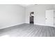 Bright bedroom with gray wood floors and an ensuite bathroom view at 14112 Monserrate Ln, Port Charlotte, FL 33981