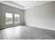 Bright, empty bedroom with hardwood floors, two windows, and tray ceiling detail at 14112 Monserrate Ln, Port Charlotte, FL 33981