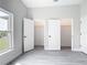 Bedroom featuring two closets, a window, and light grey wood-look floors at 14112 Monserrate Ln, Port Charlotte, FL 33981