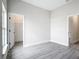 Neutral bedroom with gray wood floors and two open doorway views at 14112 Monserrate Ln, Port Charlotte, FL 33981