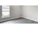 Corner bedroom with an exterior window and gray wood floors at 14112 Monserrate Ln, Port Charlotte, FL 33981