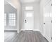 Welcoming entryway with modern gray vinyl flooring and plenty of natural light from a window at 14112 Monserrate Ln, Port Charlotte, FL 33981