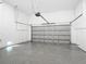 Spacious garage with epoxy flooring and a grey garage door at 14112 Monserrate Ln, Port Charlotte, FL 33981