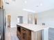 Open concept kitchen island featuring modern cabinets, stainless microwave, and seamless view to living area at 14112 Monserrate Ln, Port Charlotte, FL 33981