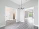 Open-concept living area showcasing gray wood floors and doorways leading to other rooms of the home at 14112 Monserrate Ln, Port Charlotte, FL 33981