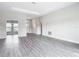 Large living space showcasing an open floor plan with gray wood floors and neutral walls at 14112 Monserrate Ln, Port Charlotte, FL 33981