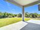 The covered patio with a view of the green backyard at 14112 Monserrate Ln, Port Charlotte, FL 33981
