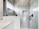 Bright shower featuring gray tile, a window, and a shower niche at 14112 Monserrate Ln, Port Charlotte, FL 33981