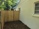 Small side yard with a wooden fence and access gate at 2309 22Nd W Ave, Bradenton, FL 34205