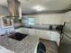 Modern kitchen with white cabinets, granite countertops and stainless steel appliances at 2309 22Nd W Ave, Bradenton, FL 34205