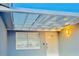 Covered entryway with a light blue exterior and glass roof at 4229 Floramar Ter, New Port Richey, FL 34652