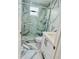Modern bathroom with marble tile, a large shower, and white vanity at 4229 Floramar Ter, New Port Richey, FL 34652