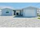 Newly renovated house with a light blue exterior, two-car garage, and paved driveway at 4229 Floramar Ter, New Port Richey, FL 34652