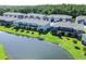 Aerial view of townhouses and lake at 1909 Hovenweep Rd, Wesley Chapel, FL 33543