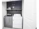 Laundry room with washer, dryer, and shelving at 1909 Hovenweep Rd, Wesley Chapel, FL 33543