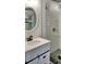 Bathroom features a white vanity and shower with a glass enclosure and white subway tile at 406 E Young St, Plant City, FL 33563