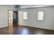 Spacious bedroom featuring wood floors, two windows, a modern light fixture, and en suite bathroom at 406 E Young St, Plant City, FL 33563