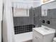 Clean bathroom with white vanity and black and white tile at 406 E Young St, Plant City, FL 33563