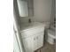 Bathroom with white vanity and marble tile at 12122 Clarendon Ave, Port Charlotte, FL 33981