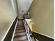 Carpeted staircase leading to upper level at 13824 Orange Sunset Dr # 202, Tampa, FL 33618