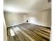 Large living area with wood-look floors and neutral walls at 13824 Orange Sunset Dr # 202, Tampa, FL 33618
