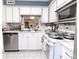 Bright kitchen featuring white cabinetry, stainless steel appliances, and ample counter space at 4222 Trucious Pl # 4222, New Port Richey, FL 34652